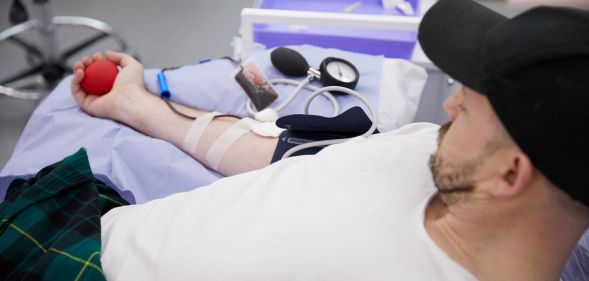 A queer man donates blood at the 'illegal blood bank', set up by activists to highlight backwards laws. (UNILAD)