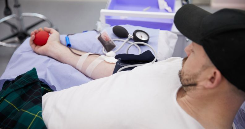 A queer man donates blood at the 'illegal blood bank', set up by activists to highlight backwards laws. (UNILAD)