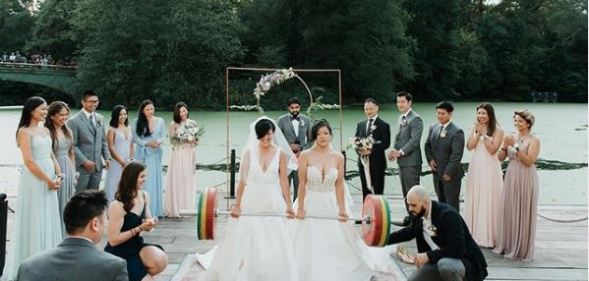 Lesbian weightlifting couple show off strength in stunning viral wedding photo