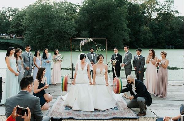 Lesbian weightlifting couple show off strength in stunning viral wedding photo