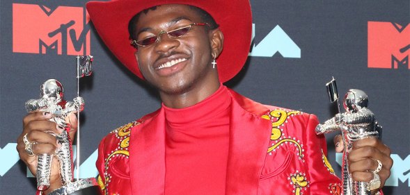Lil Nas X holding two MTV Awards