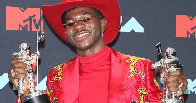 Lil Nas X holding two MTV Awards