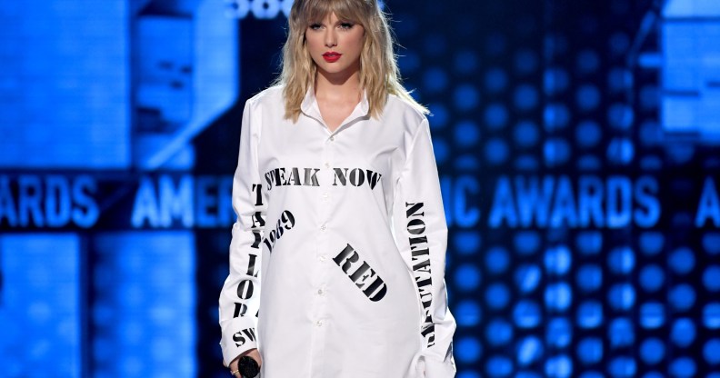 Taylor Swift wearing a shirt with the names of her first six albums at the AMAs