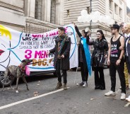 Members of LGBTQ community stage a 'marriage' between three men and a dog during a protest against Boris Johnson