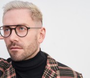 Kit Williamson holding his glasses