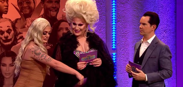 Baga Chipz wafting a card over The Vivienne's crotch as Jimmy Carr looks on