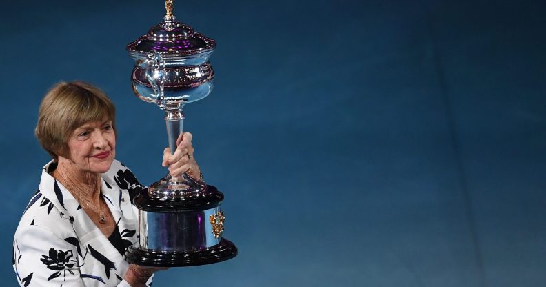 Former Australian tennis player Margaret Court poses with a replica of the trophy to commemorate 50 years of her Australian grand slam win