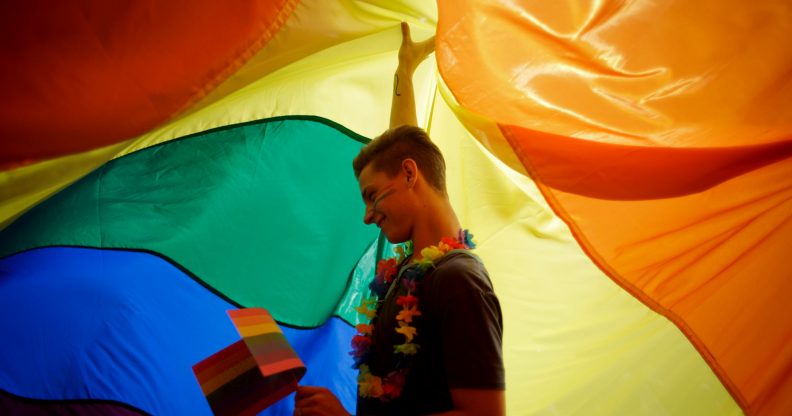 Participant dances as he holds up a large rainbow flag during the third Prague Pride March on August 17, 2013 in Prague, Czech Republic. (Matej Divizna/Getty Images)