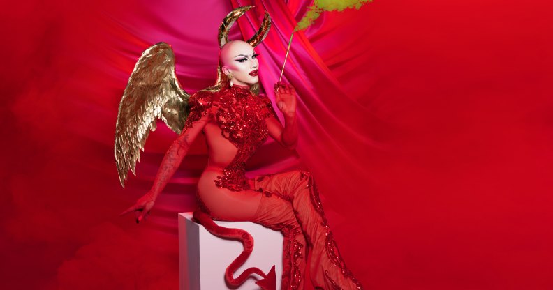 Sasha Velour dressed as a devil with gold wings