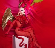 Sasha Velour dressed as a devil with gold wings