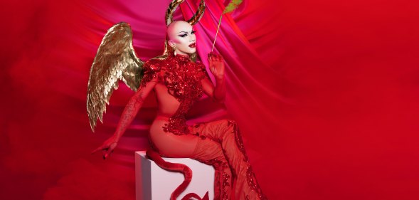 Sasha Velour dressed as a devil with gold wings