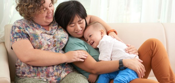 cisgender same-sex couple with baby