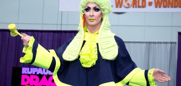 Detox in a green judges wig, holding a gavel