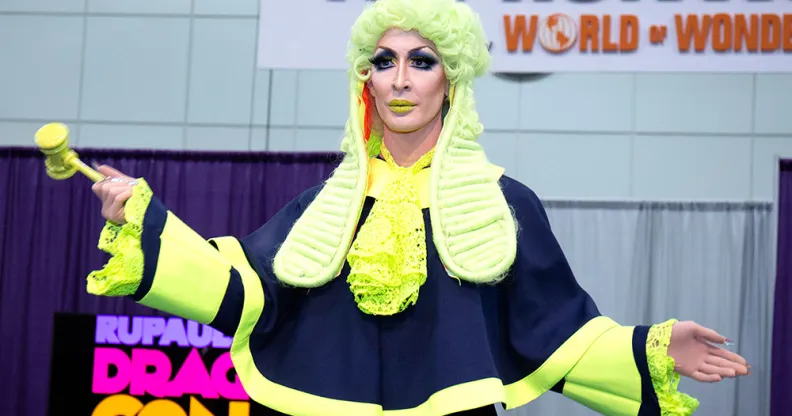 Detox in a green judges wig, holding a gavel