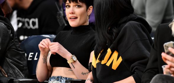 Halsey at a basketball game, looking worried