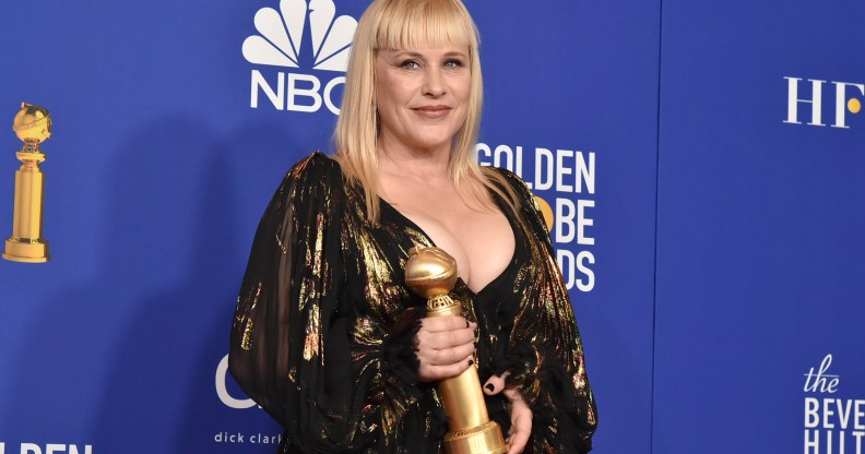 Patricia Arquette holding her Golden Globes 2020 award
