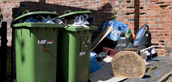 Full household waste wheelie bins and rubbish.