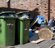 Full household waste wheelie bins and rubbish.