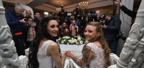 Robyn Peoples, from Belfast, and Sharni Edwards, from Brighton, pose for the media after getting married on February 11, 2020 in Carrickfergus, Northern Ireland.
