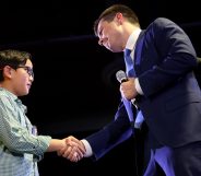 Democratic presidential candidate Buttigieg greets Zachary Ro, who asked Buttigieg to help him tell others he is gay, while the candidate was speaking at a town hall campaign even. (xWin McNamee/Getty Images)
