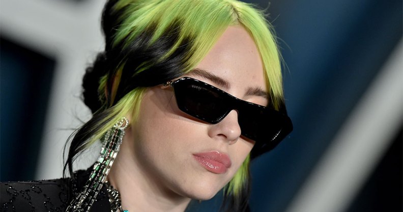 Billie Eilish with green hair and sunglasses