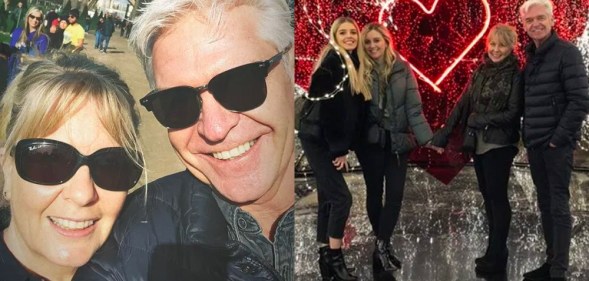 Phillip Schofield smiling with his wife Stephanie / posing with their daughters in front of a red love heart