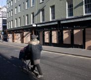 Bars and restaurants boarded up and closed down on Old Compton Street in Soho, at the heart of the West End