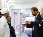 Prince Harry meets catering staff during his visit to Mildmay hospital, a dedicated HIV hospital. (Yui Mok-WPA Pool/Getty Images)