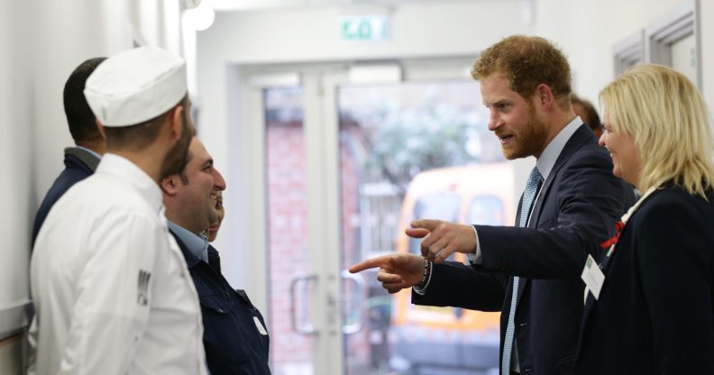 Prince Harry meets catering staff during his visit to Mildmay hospital, a dedicated HIV hospital. (Yui Mok-WPA Pool/Getty Images)