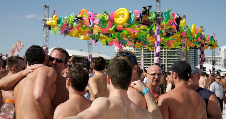 A group of men hugging at the Winter Party Festival on Miami Beach. At least one attendee in 2020 acquired the coronavirus, according to organisers. (Jeffrey Greenberg/Universal Images Group via Getty Images)