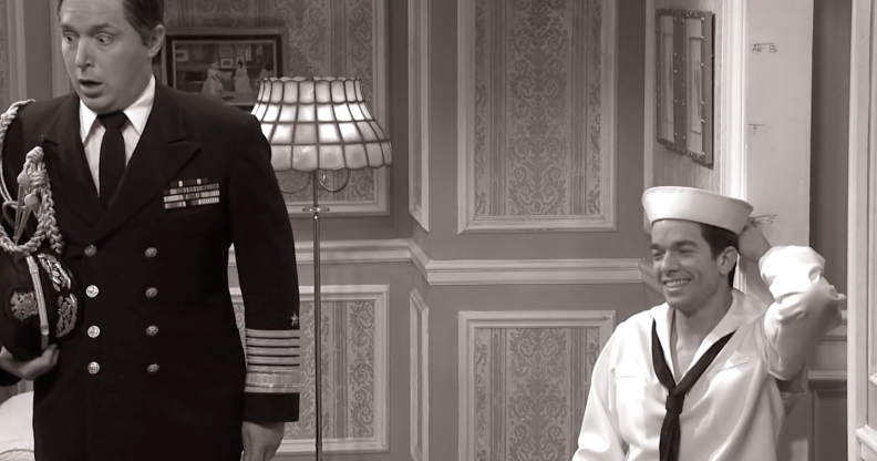 John Mulaney (L) coyly squats down to the astonished delight of Beck Bennett in the Saturday Night Live skit. (Screen capture via YouTube)