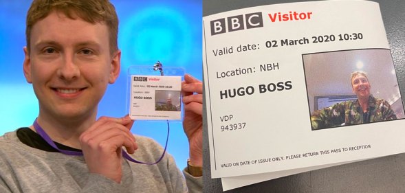 Joe Lycett holding a BBC visitor pass with the name Hugo Boss