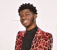 Lil Nas X in an orange leopard print suit