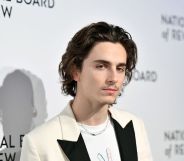 Timothee Chalamet in a suit on the red carpet - the suit is white with black lapels
