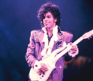 Prince performing on stage during his Purple Rain tour.