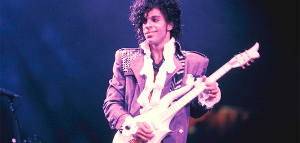 Prince performing on stage during his Purple Rain tour.