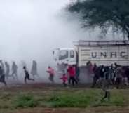 Harrowing footage seen by PinkNews shows Kakuma refugee camps sprinting as teargas engulfs them. Multiple nondescript bangs can be heard in the distance. (Screen capture via Facebook)