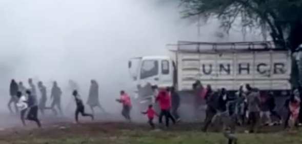 Harrowing footage seen by PinkNews shows Kakuma refugee camps sprinting as teargas engulfs them. Multiple nondescript bangs can be heard in the distance. (Screen capture via Facebook)