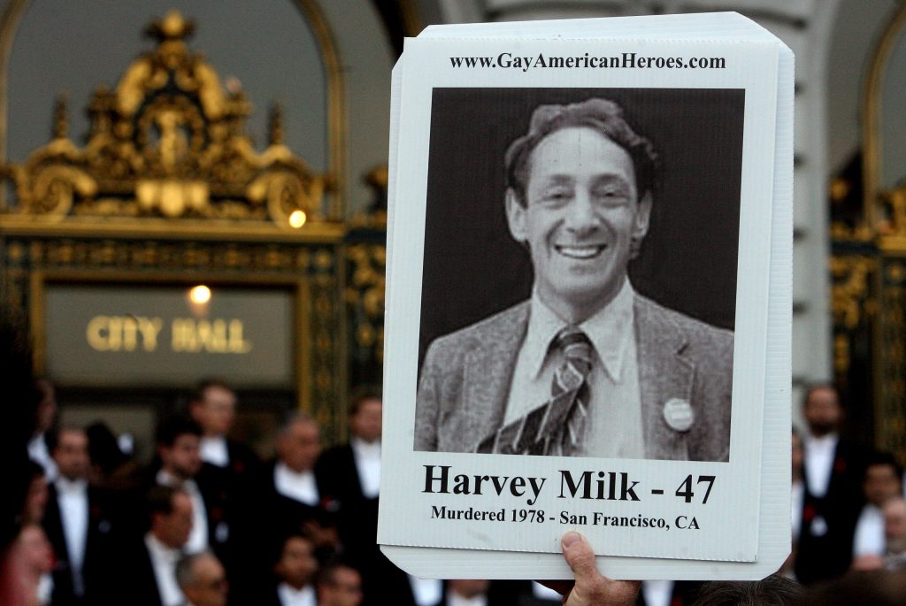 An attendee holds a picture of Harvey Milk at a memorial event marking 30th anniversary of killings of George Moscone and Harvey Milk at City Hall in San Francisco, California. (Mark Constantini/San Francisco Chronicle via Getty Images)