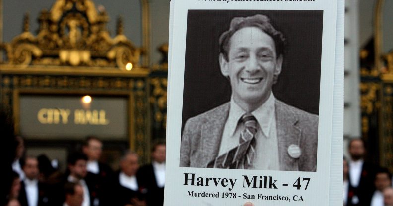 An attendee holds a picture of Harvey Milk at a memorial event marking 30th anniversary of killings of George Moscone and Harvey Milk at City Hall in San Francisco, California. (Mark Constantini/San Francisco Chronicle via Getty Images)