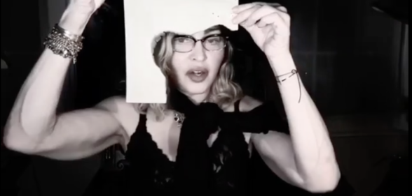 Madonna shows viewers the singed paper she's typing on. (Screen capture via Instagram)