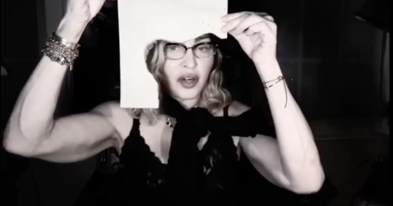 Madonna shows viewers the singed paper she's typing on. (Screen capture via Instagram)
