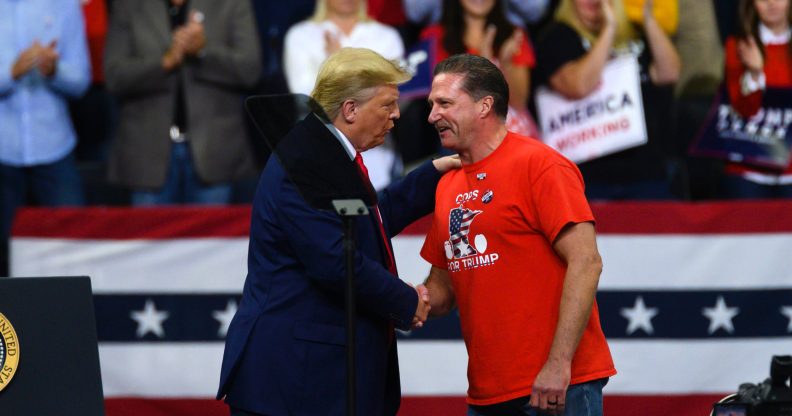 US president Donald Trump shakes hands with Minneapolis Police Union head Bob Kroll on stage during a campaign rally at the Target Center on October 10, 2019 in Minneapolis, Minnesota
