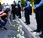 Protesters lay flowers at the feet of Chicago Police Department officers on June 06, 2020 in Chicago, Illinois.
