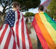 A couple holds hands, draped in flags, as they celebrate the Supreme Court ruling on same-sex marriage on June 26, 2015 in West Hollywood, California.