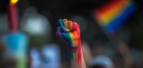A defiant fist is raised at a vigil for the second-worst mass shooing in US history, the Pulse nightclub shooting, on June 13, 2016. (David McNew/Getty Images)