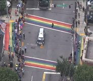 The casket of John Lewis, a towering giant in the civil rights movement, pauses as crowds cheer at a Pride flag-inspired crossroads in Atlanta, US. (Screen capture via Facebook)