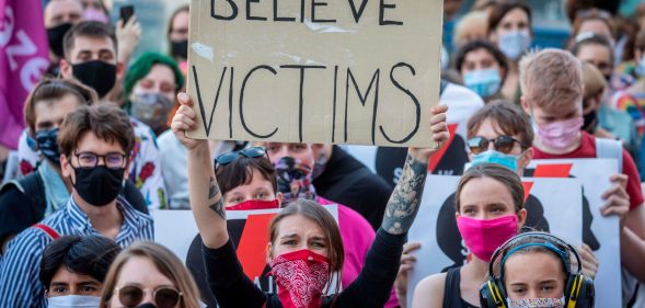 A protester holds a banner reading Believe Victims as she takes part in a protest against the Polish government plans to withdraw from the Istanbul Convention