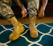 Army Sergeant Shane Ortega laces up boots before posing for a portrait at home at Wheeler Army Airfield on March 26, 2015 in Wahiawa, Hawaii.