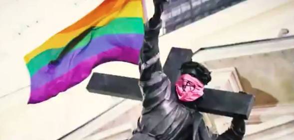 Jesus statue with rainbow flag and anarchist bandana